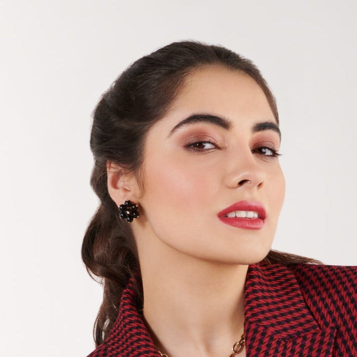 Model wearing handcrafted 18ct yellow gold earrings featuring a cluster of black onyx beads, interspersed with small diamonds.