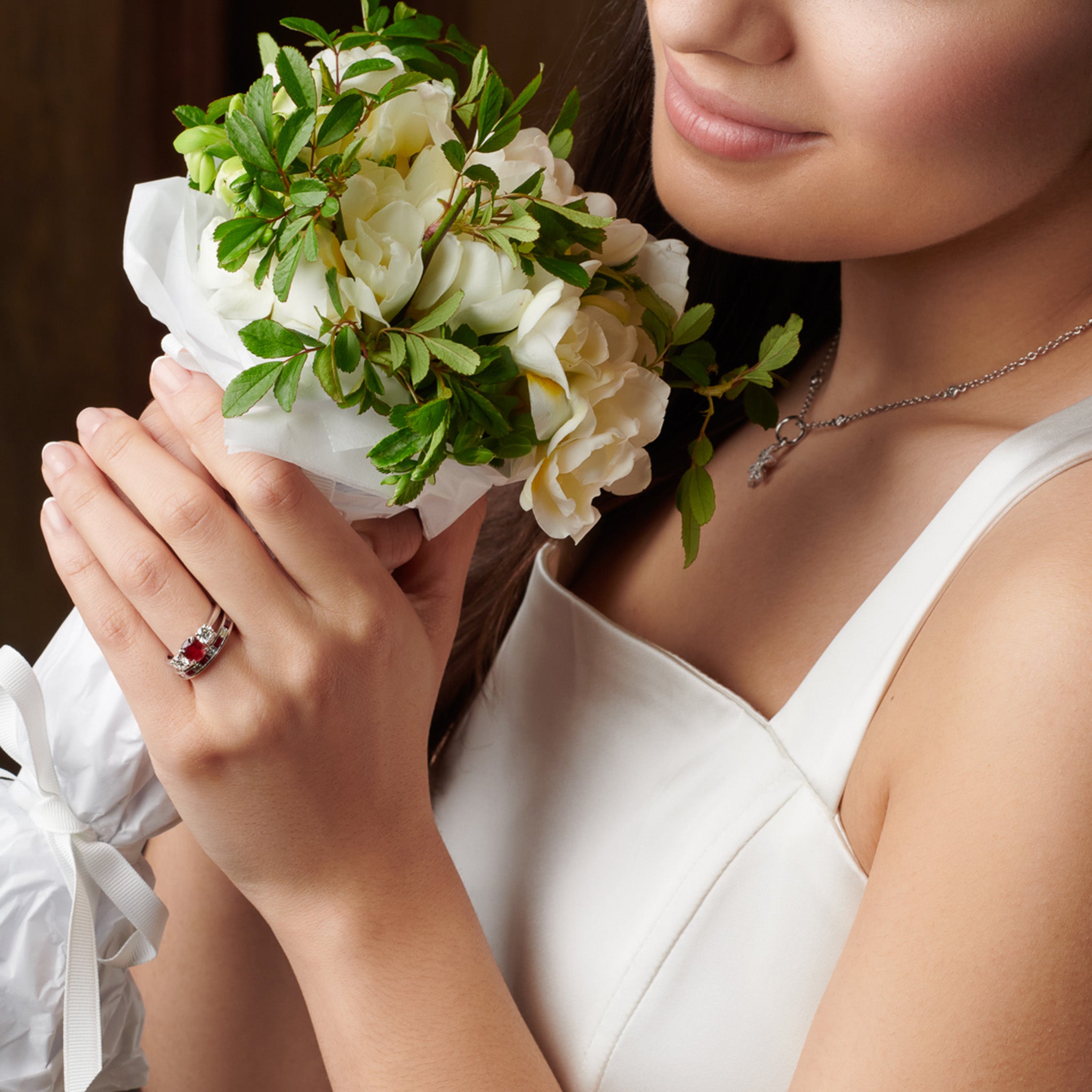 Model wearing a handcrafted 18ct yellow gold half eternity ring with rubies and diamonds.