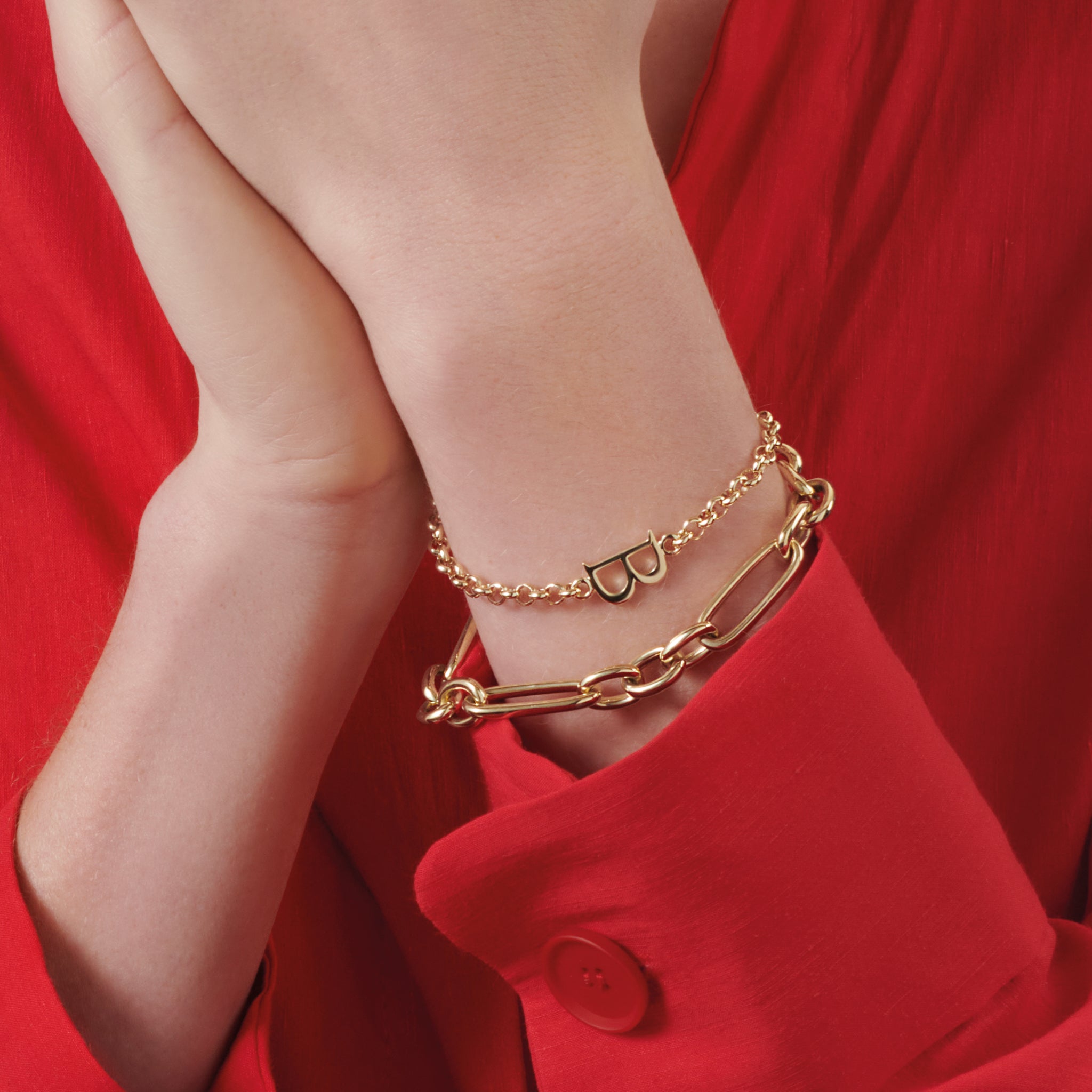 Handcrafted yellow gold bracelet with a central yellow gold letter accent.