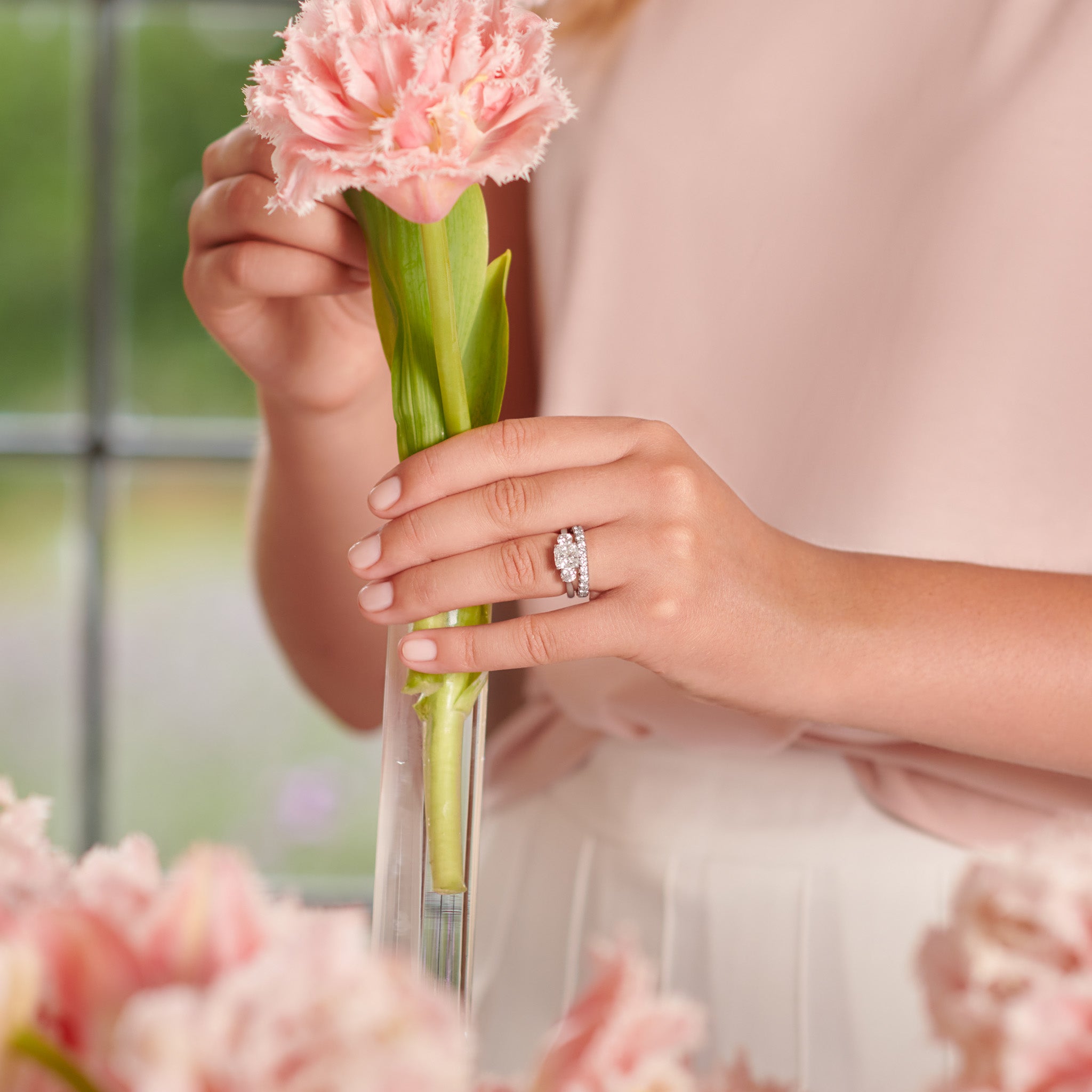 Model wearing a handcrafted 18ct white gold eternity ring with diamonds.
