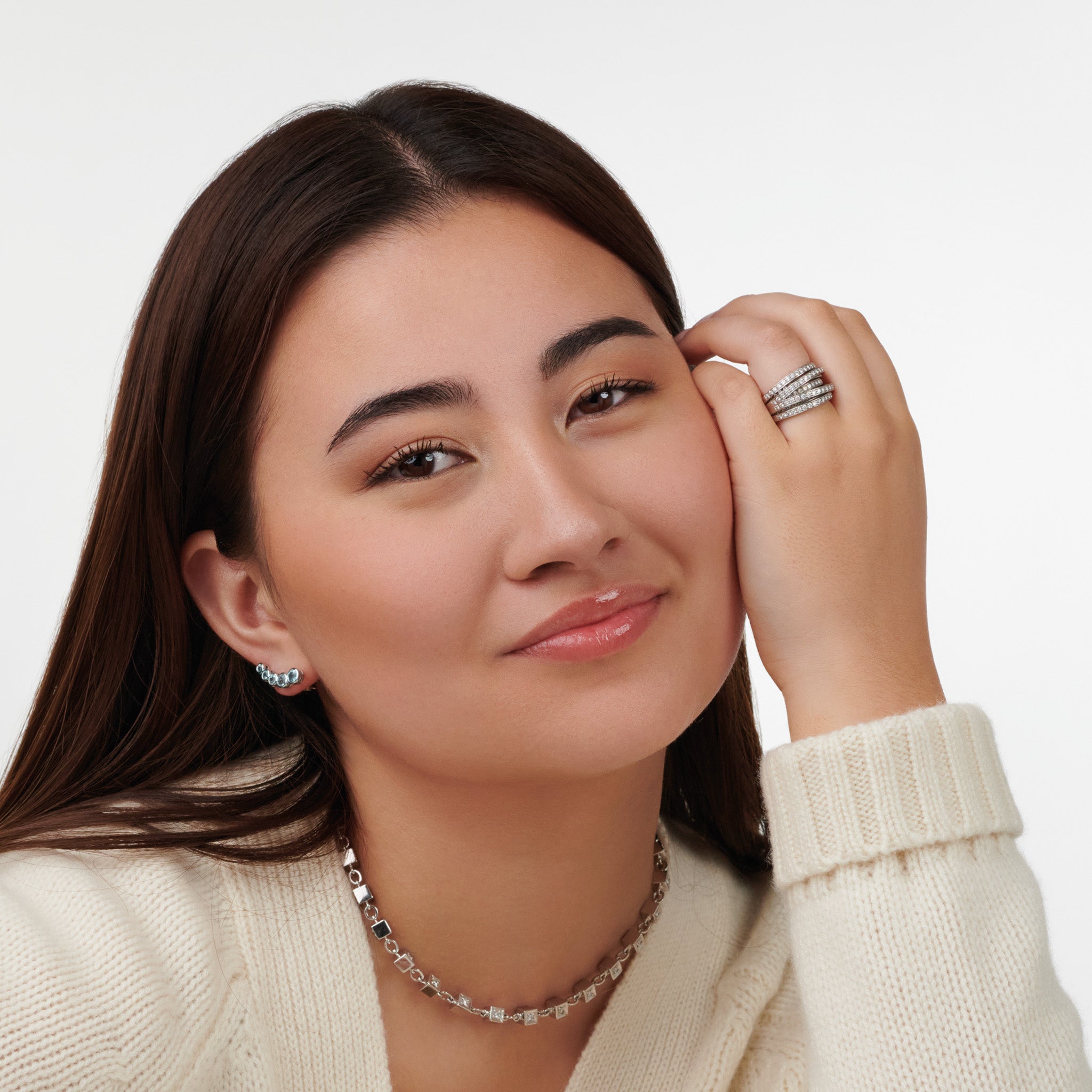 Model wearing a handcrafted 18ct white ring featuring a nest of tagliatelle with diamonds.
