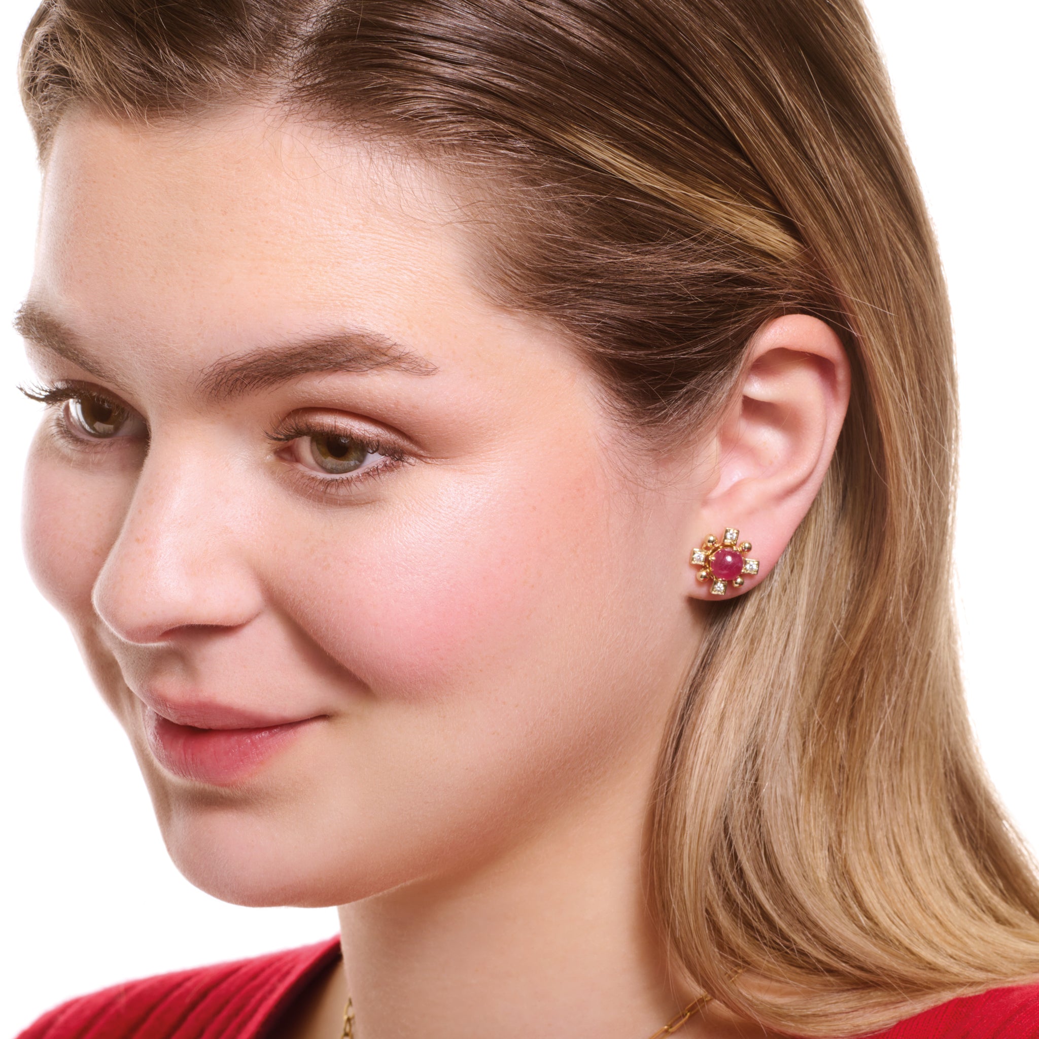 Model wearing handcrafted yellow gold cross shaped earring halos with diamonds.