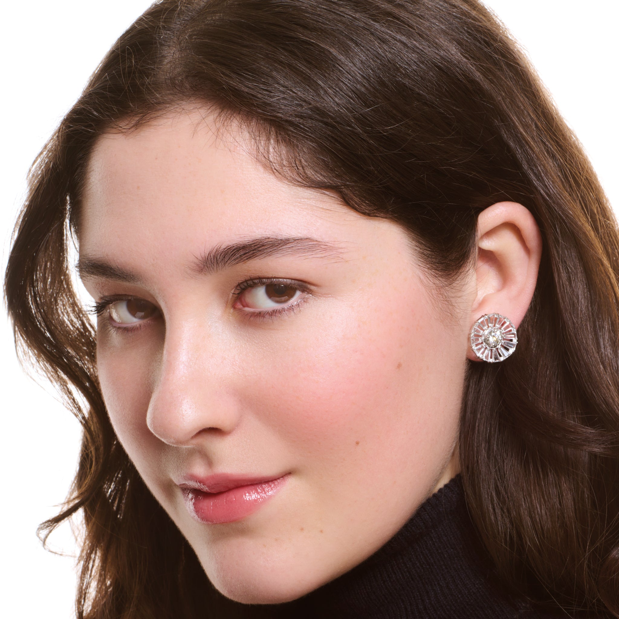 Model wearing handcrafted 18ct white gold earring halos with baguette cut precious gemstones.
