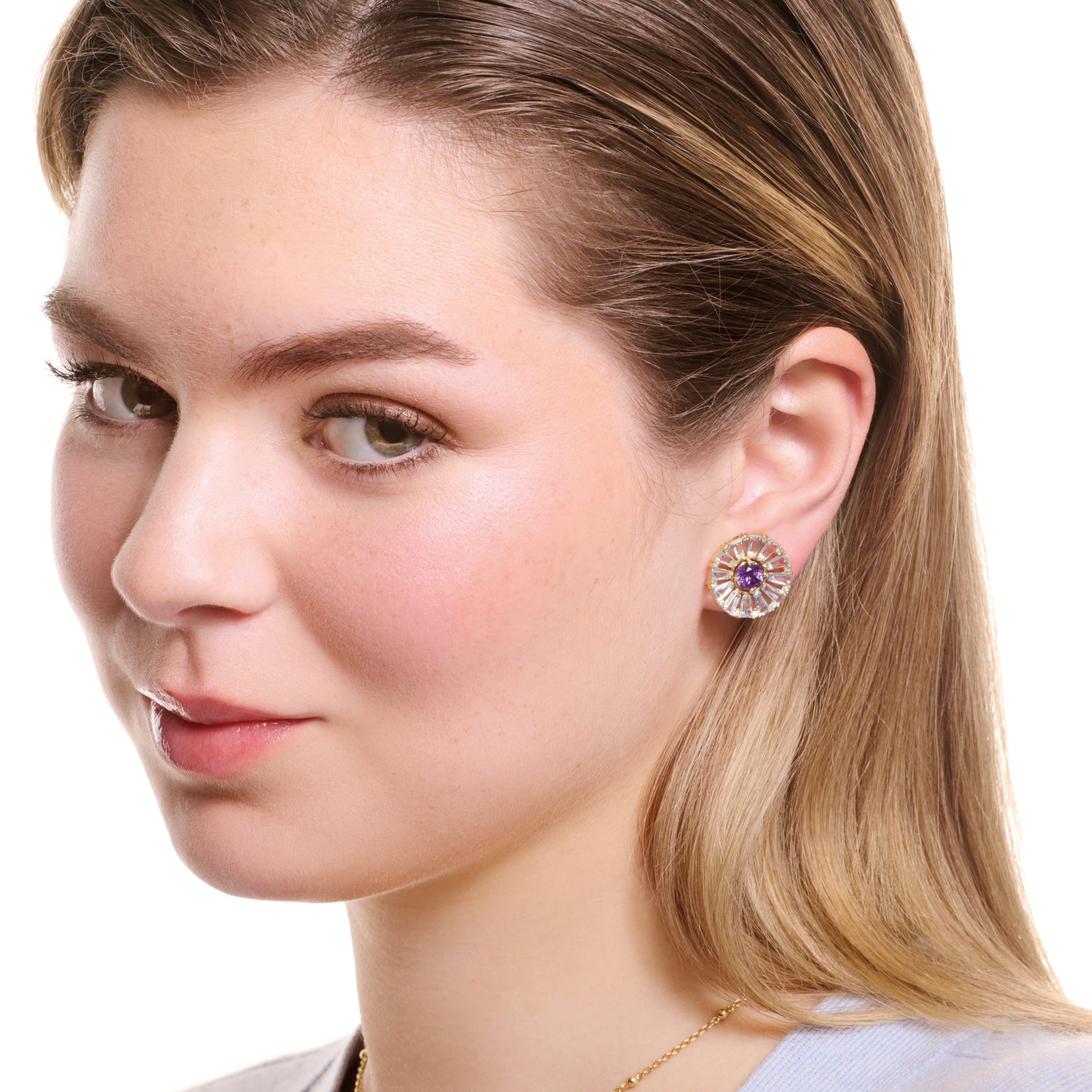 Model wearing handcrafted yellow gold earring halos with baguette cut white topaz and diamond gemstones.
