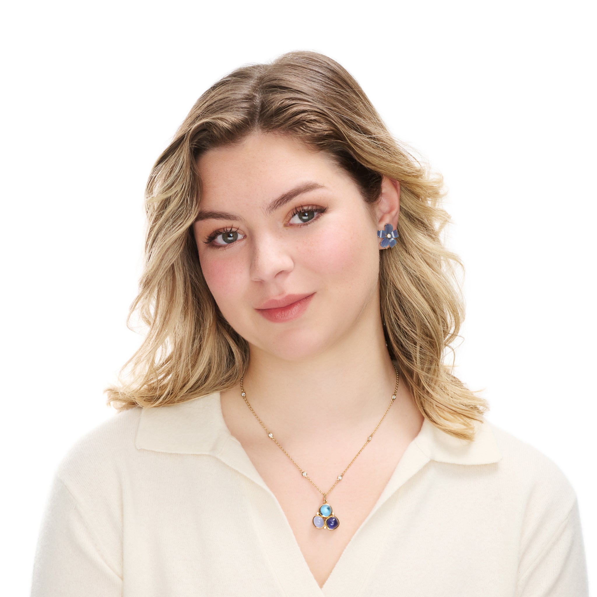 Model wearing a handcrafted 18ct yellow gold triangular necklace pendant with cabochon chalcedony, iolite, blue topaz and diamond gemstones.