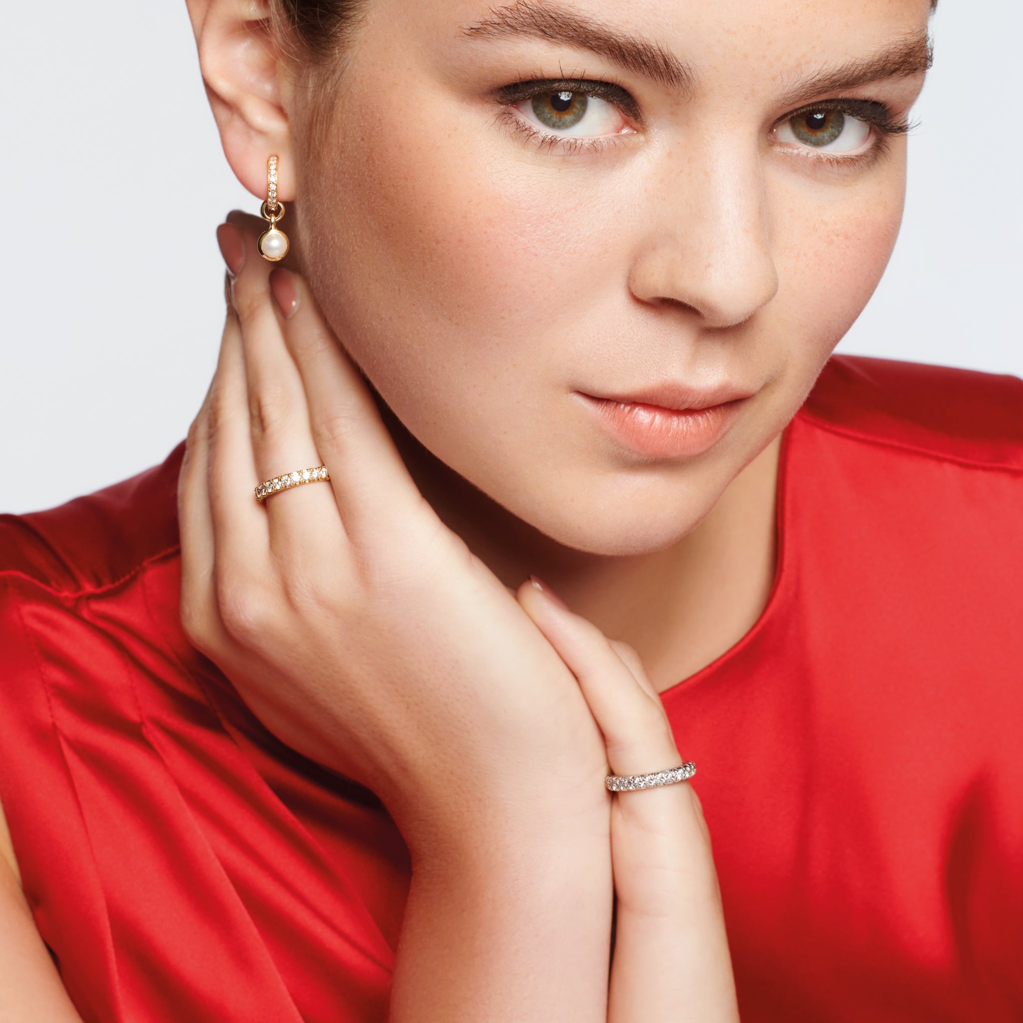 Model wearing a handcrafted 18ct yellow gold wedding band with diamonds set along the band.