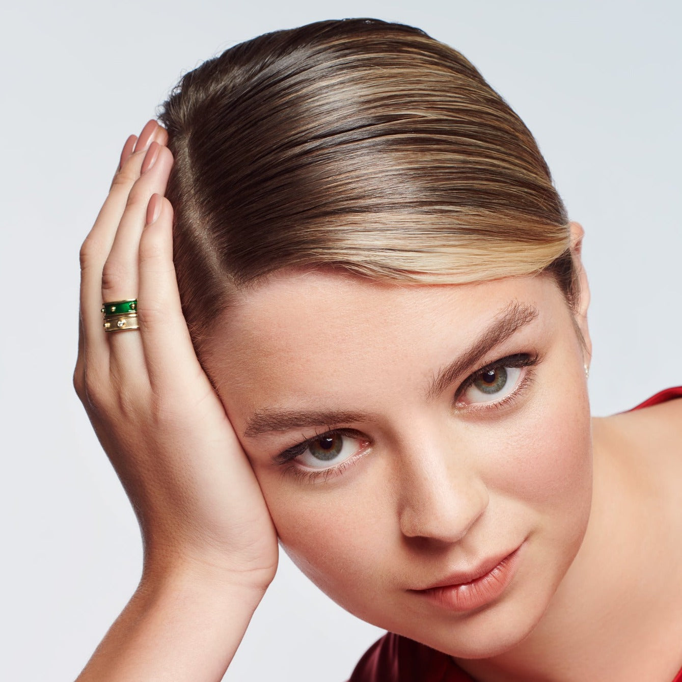 Model wearing a handcrafted 18ct yellow gold ring with evenly spaced, protruding round dots with diamond.