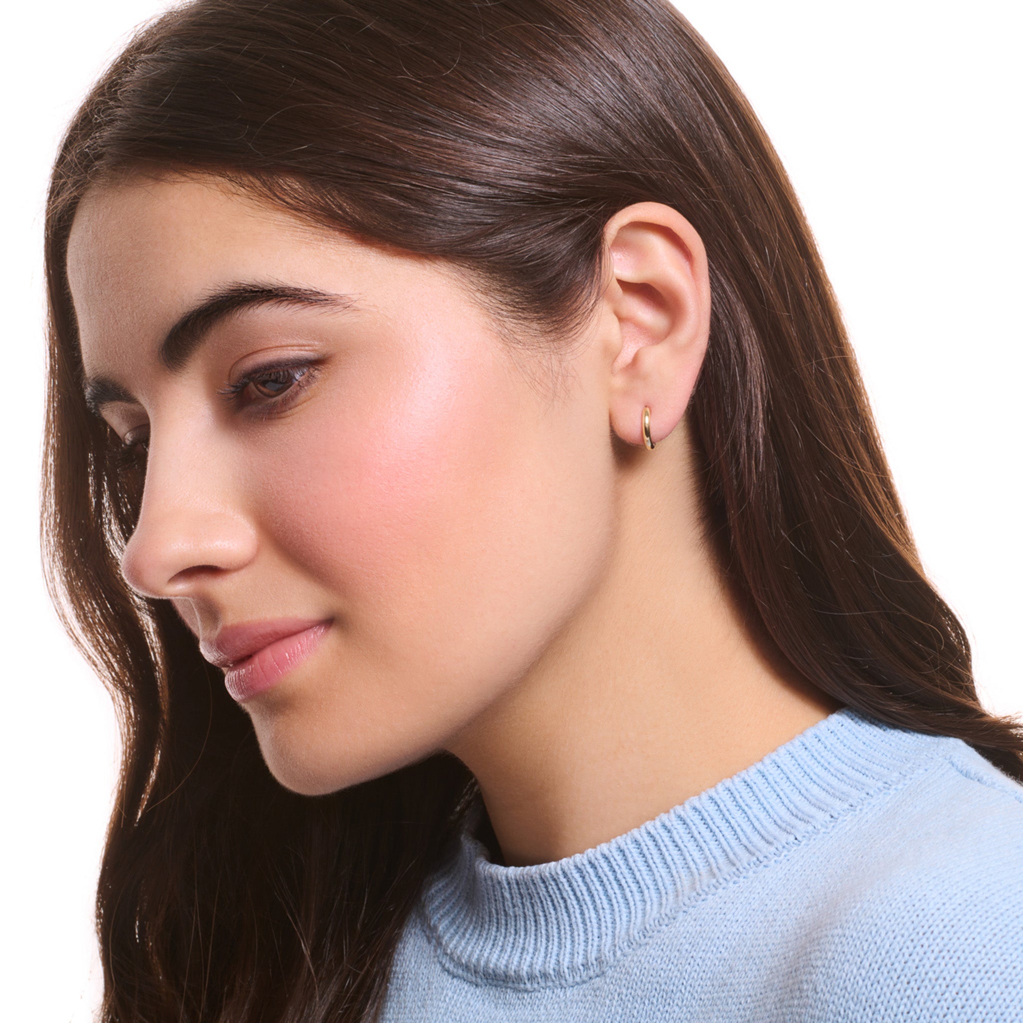 Model wearing a handcrafted yellow gold hoop earring set.