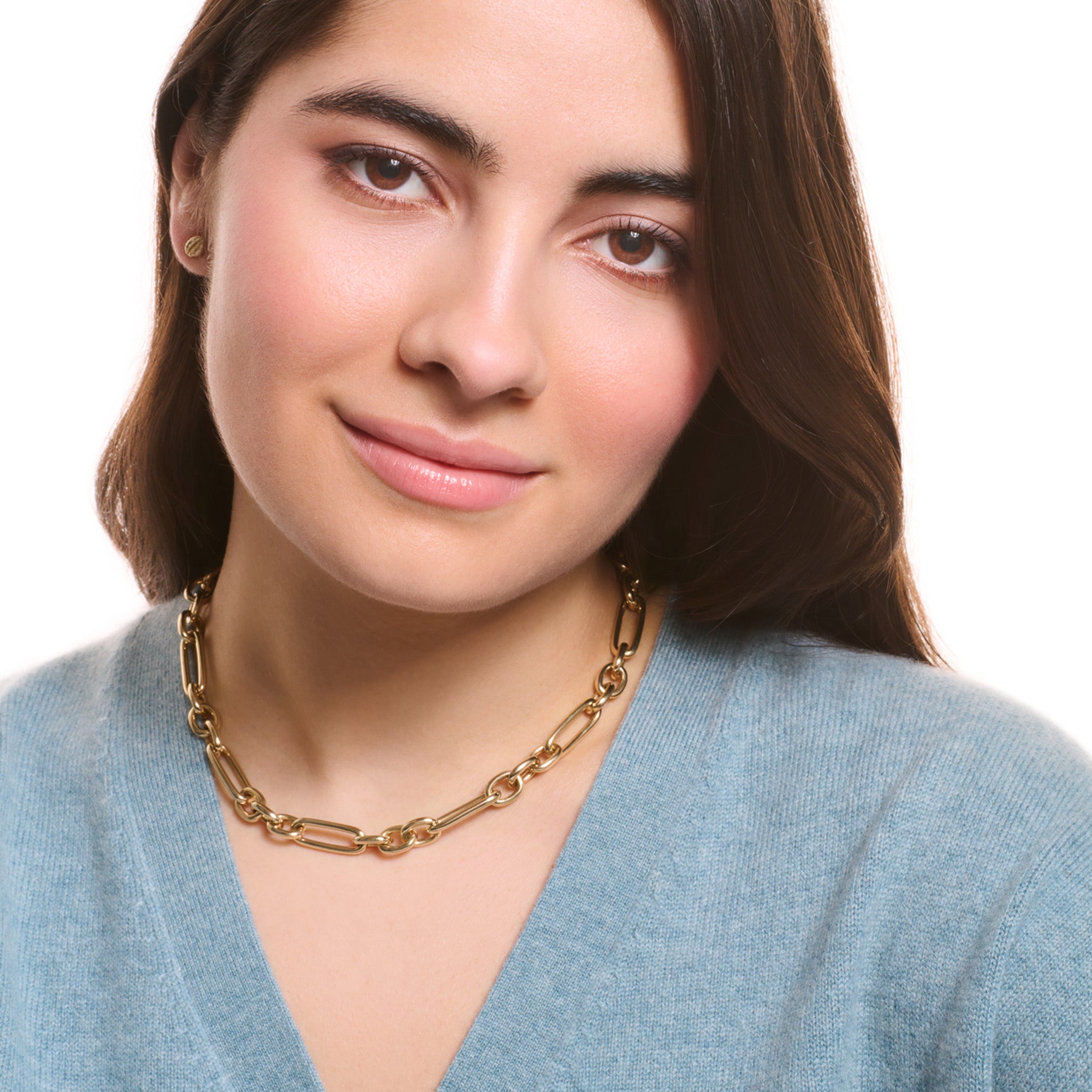 Model wearing a handcrafted yellow gold link necklace featuring chunky round and rounded rectangular links interconnected.