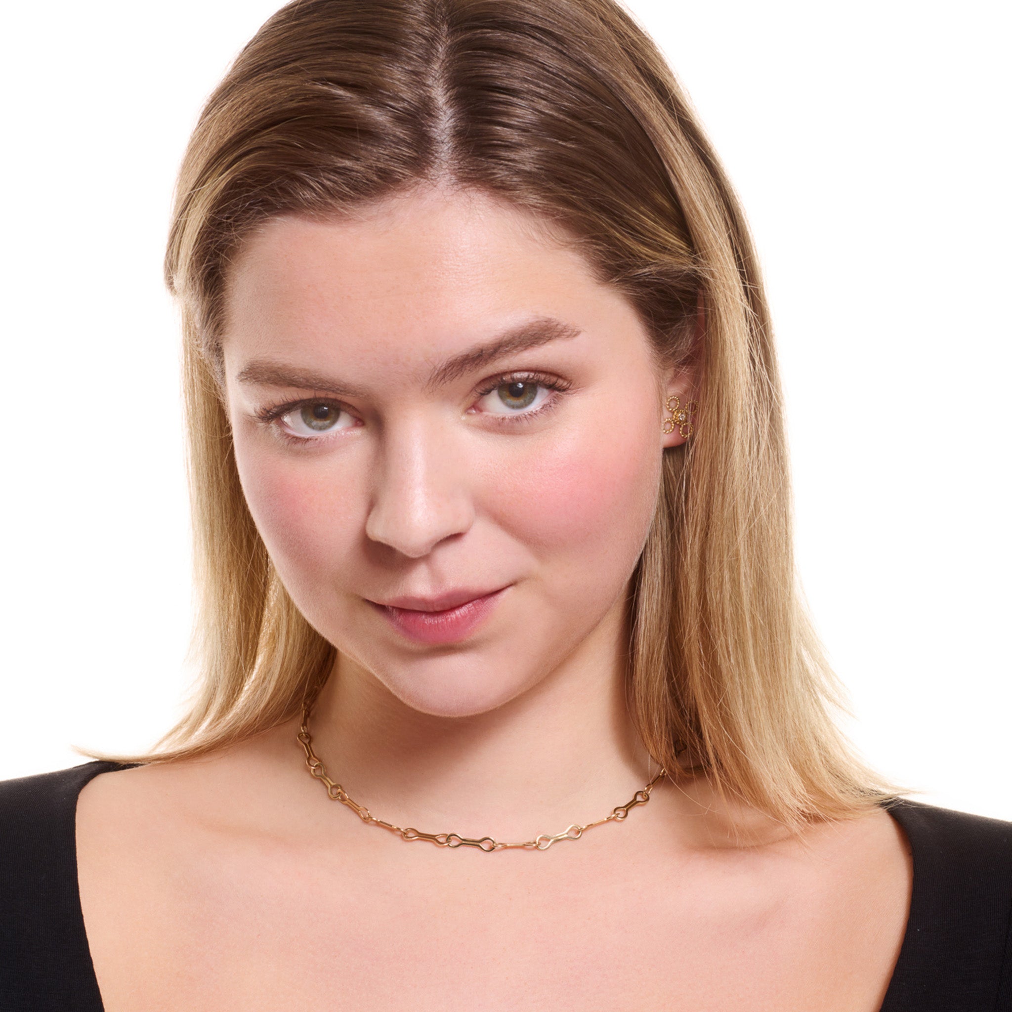 Model wearing a handcrafted yellow gold necklace chain featuring long oval links.