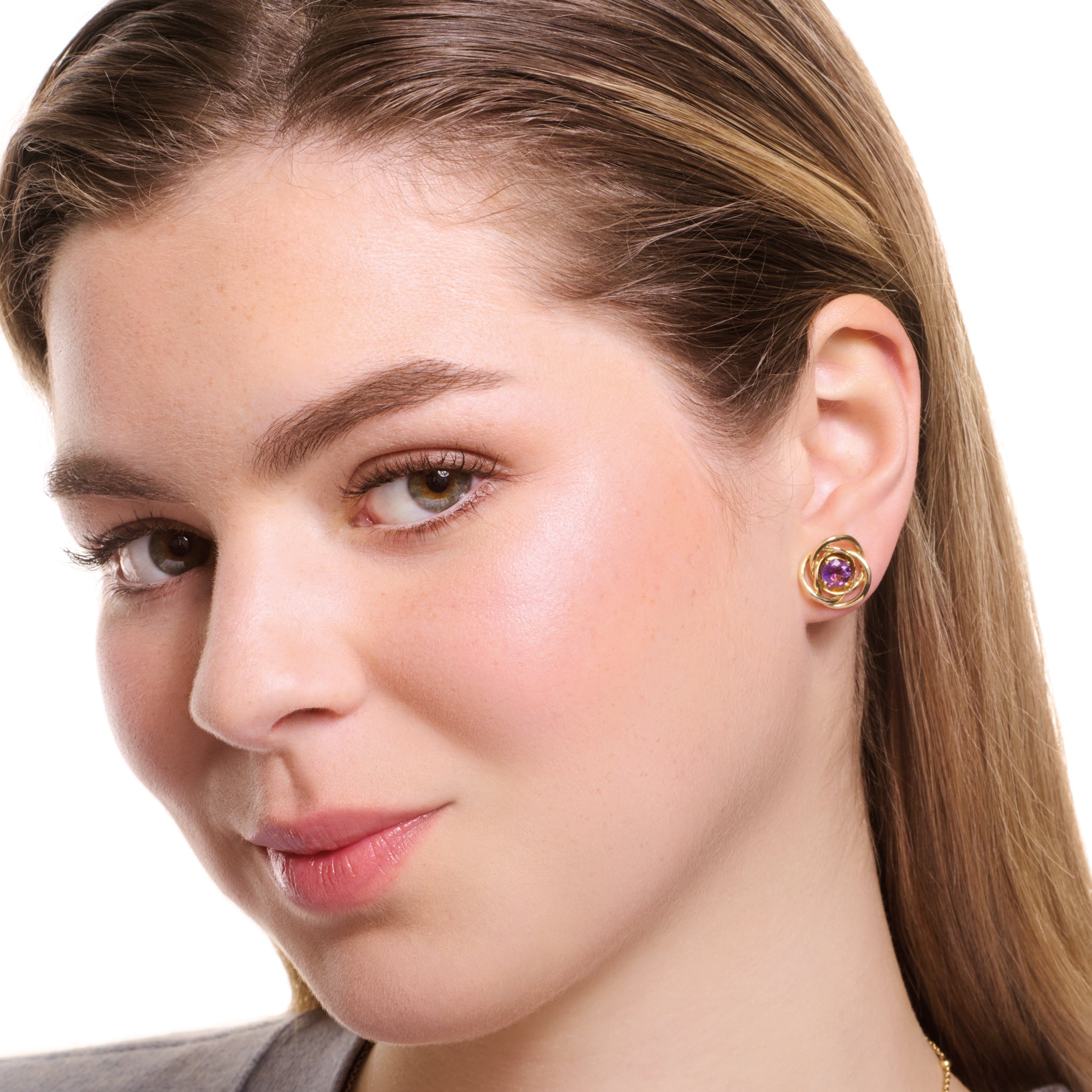 Model wearing handcrafted yellow gold earring halos featuring three layered circles.
