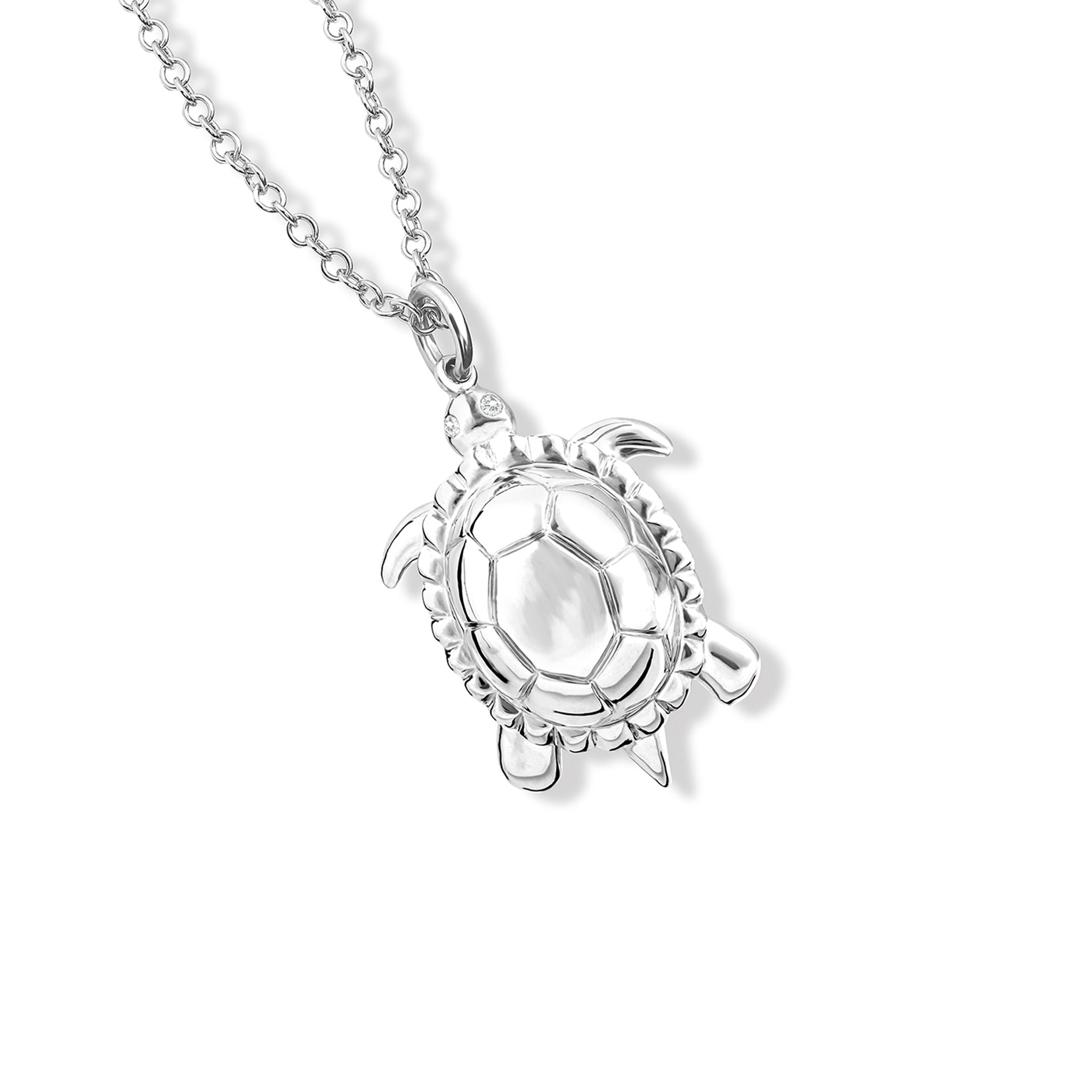 Handcrafted sterling silver tortoise shaped necklace pendant featuring diamonds.
