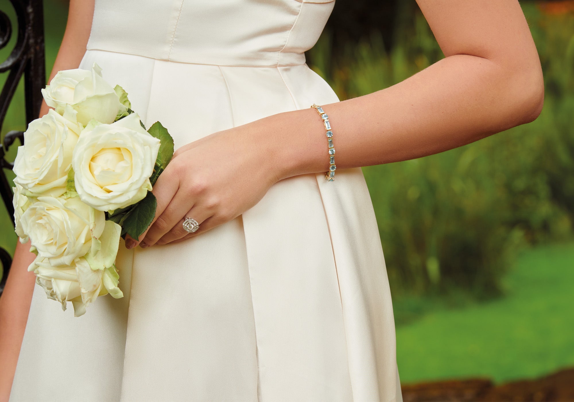 Model wearing handcrafted white gold jewellery featuring blue precious gemstones for a bride.