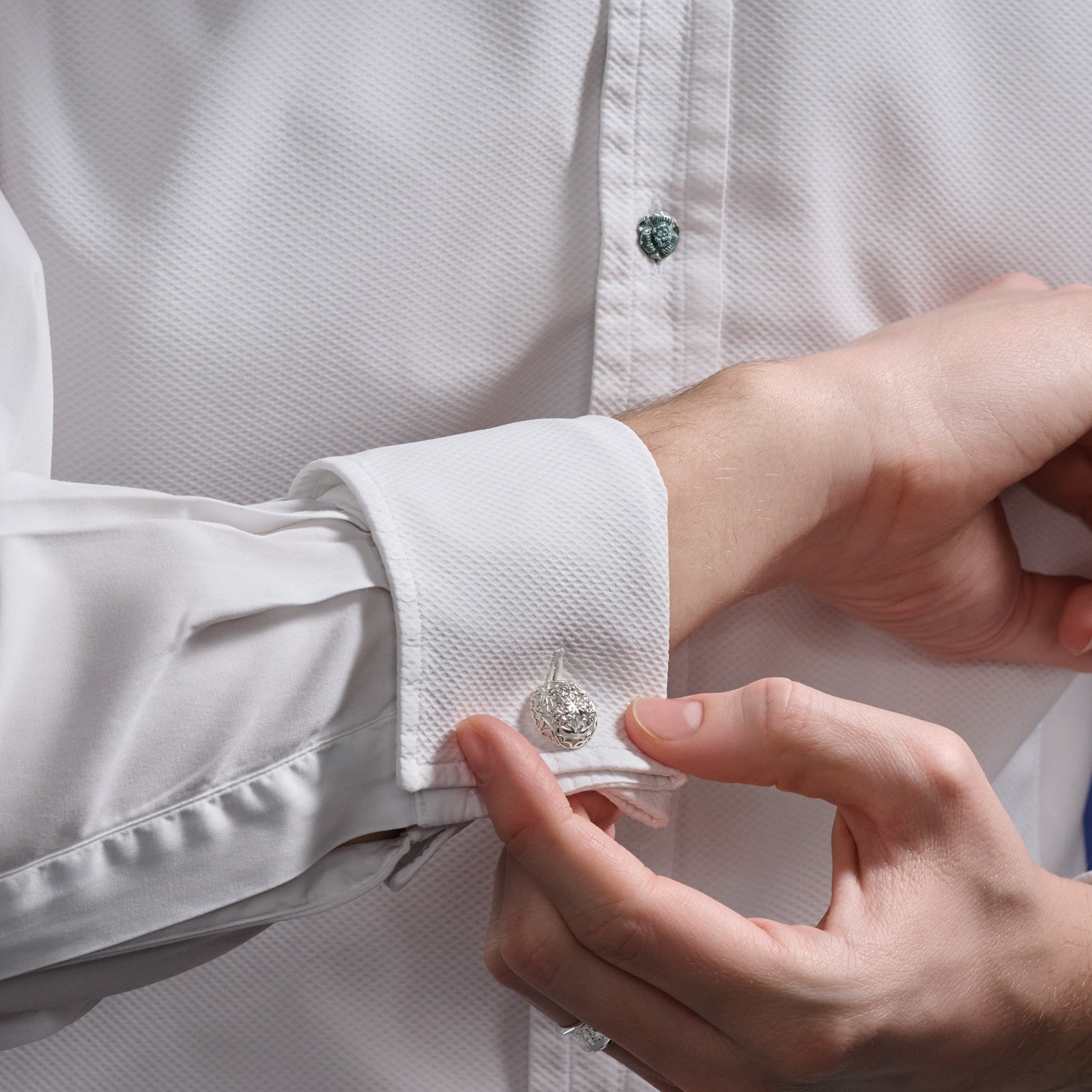 Model wearing handcrafted sterling silver Eton College Chapel single ended cufflinks.