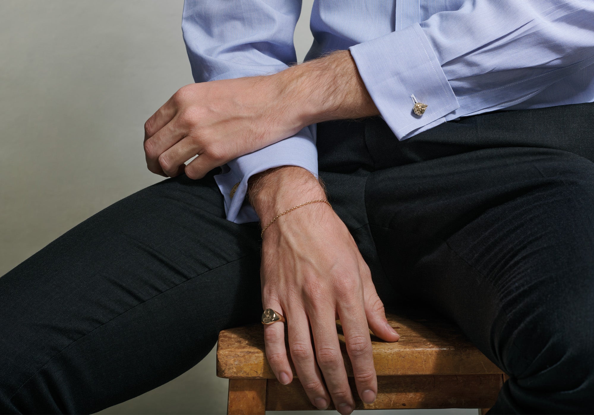 Model wearing handcrafted gold signet rings featuring die sinking process.