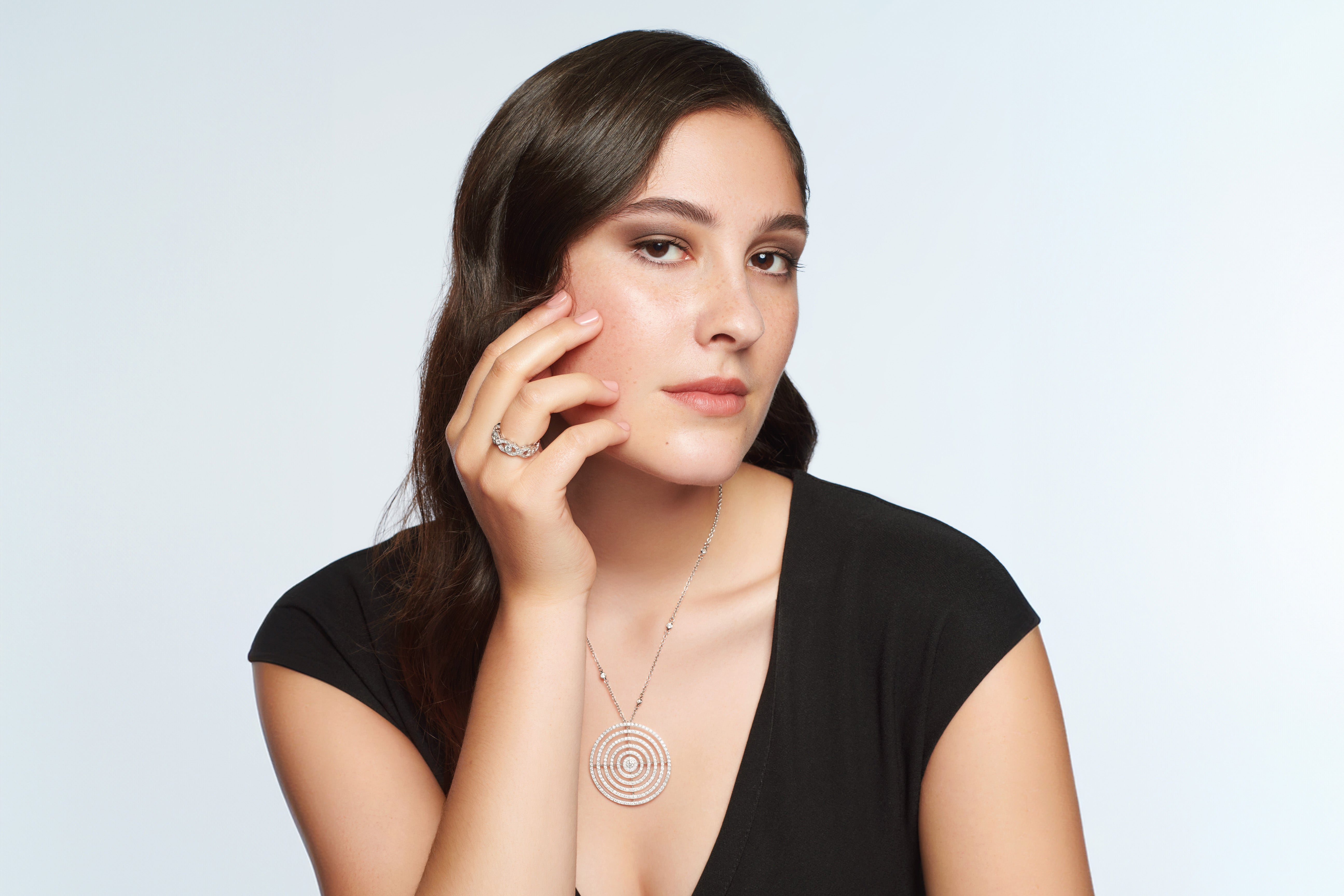 Model wearing white gold jewellery with diamonds.