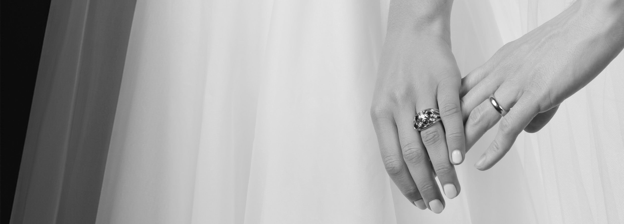 Models wearing handcrafted wedding bands.