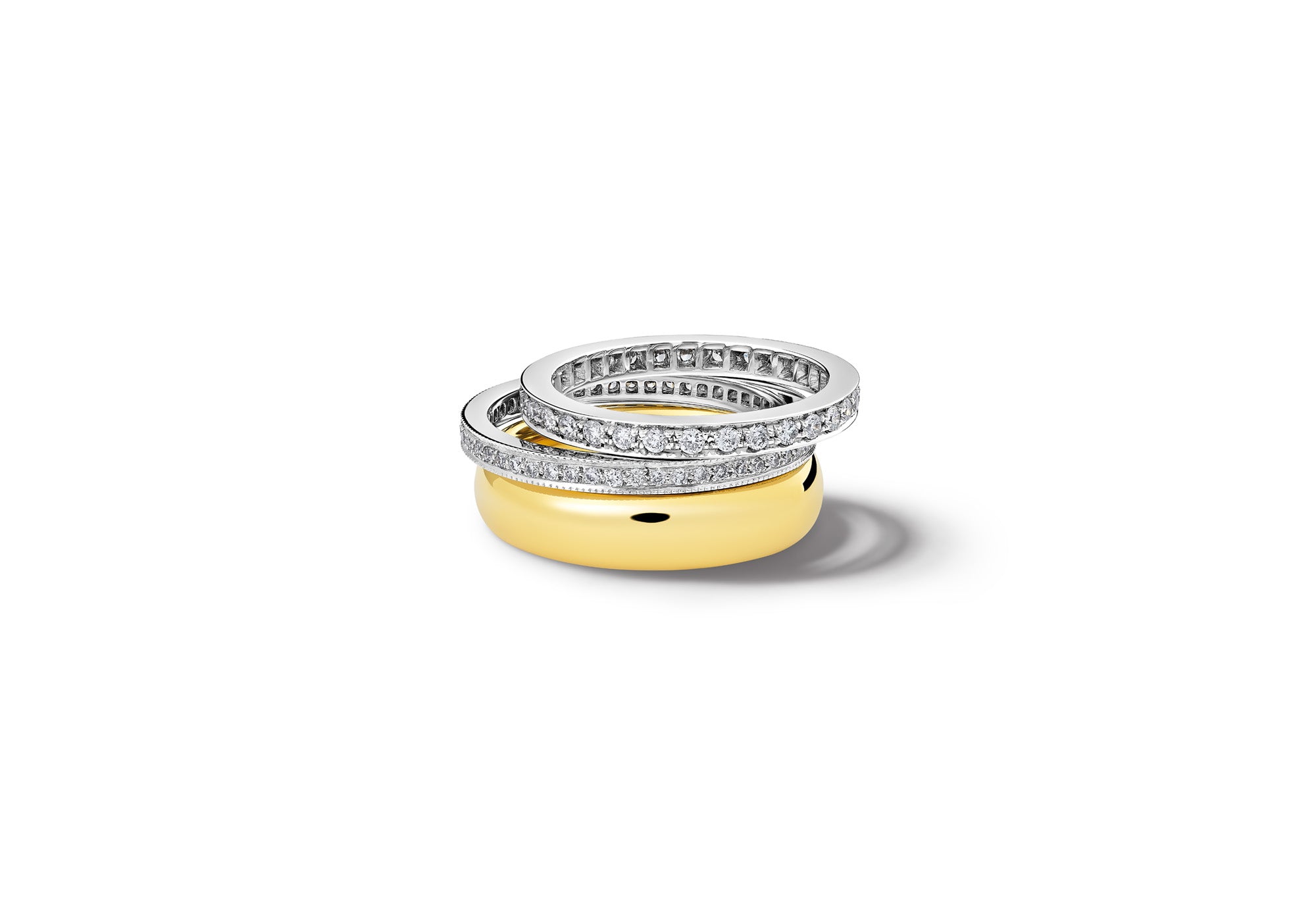 Handcrafted white and yellow gold wedding bands with precious stones.